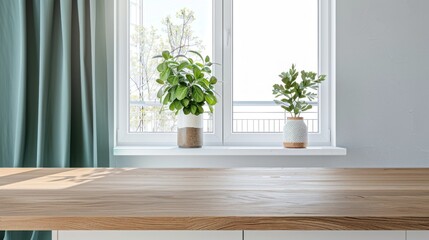 Fototapeta premium Bright indoor space features green plants on a windowsill, showcasing modern design with natural light and a wooden countertop