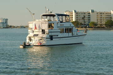 Close View from over intercoastal  towards large white Boats in the middle of water near Corey Causeway Drawbridge. Towards far shore and condos.Late afternoon sun near sunset
