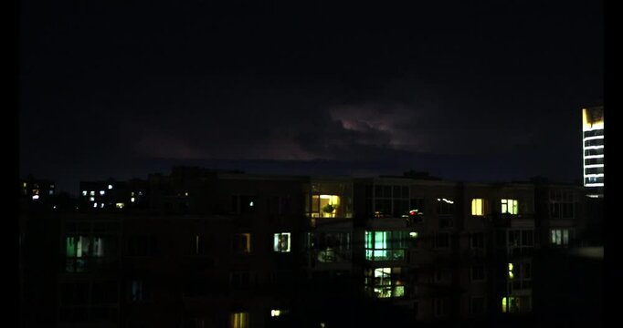 A distant lightning at night in the middle of City, Neighbourhood during the Storm