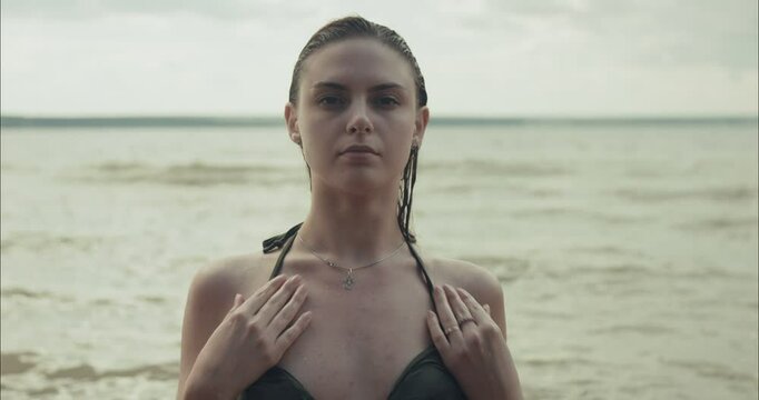 Young model posing in water at the beach