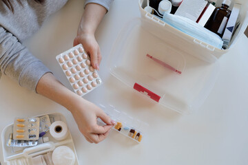 A woman takes her daily sedative or medicine for a headache or stomach pain.