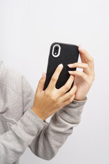 Hand holding black smartphone, isolated on white background. High-resolution photo.