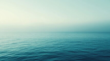 Obraz premium Serene Calm Ocean Under Soft Blue Sky in Early Morning Light