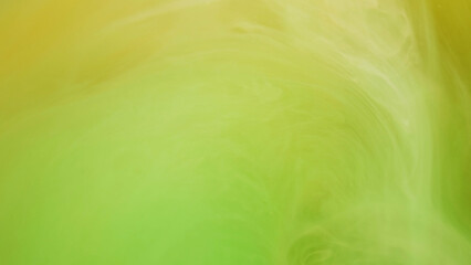 Glowing paint. Colorful mix. Defocused bright green yellow cloud splashes ink mist vortex moving on...