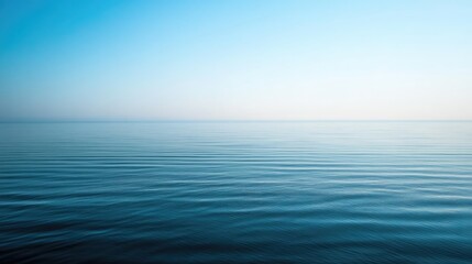 Fototapeta premium Calm Ocean Surface with Gentle Waves Under Clear Blue Sky