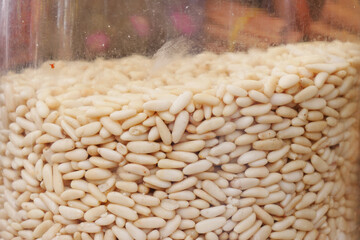 Healthy pine nuts in a jar on table 