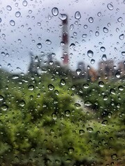 Blur bacground Rain drops on window with tower