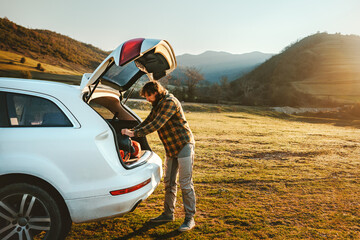 Road trip vacations - man traveling by rental car active lifestyle weekend getaway camping in...