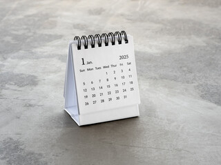 A January 2025 desk calendar for the organizer to plan and reminder, standing on cement floor...