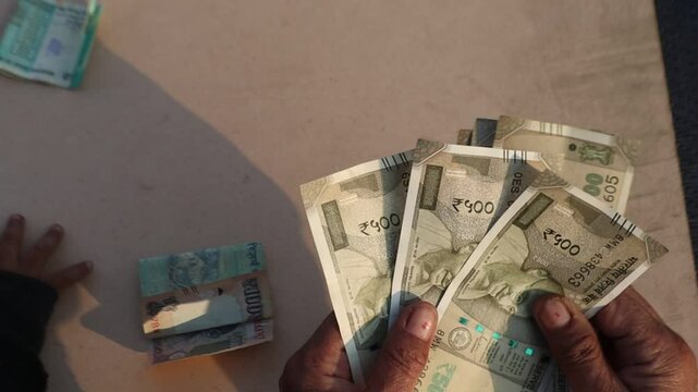 Hand holding Indian 500 rupee note representing Indian currency concepts like tax, loan, investment, banking, and financial planning. Copy space 