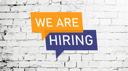 Fototapeta premium We are hiring banner on white brick wall banner.