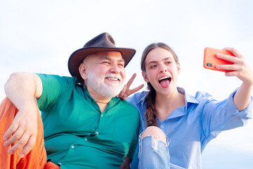 Selfie with parents. Grandchild girl teaching grandad take selfies. Daughter and old father using...