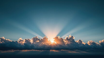 A stunning sky captures the sun rising behind clouds, casting rays of light across the horizon, creating a serene and awe-inspiring atmosphere.