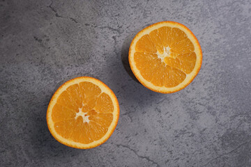 Fresh ripe oranges on grey background
