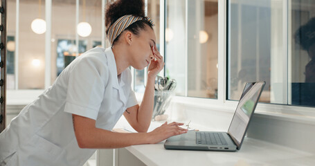 Research, tired and laptop with chef in kitchen for online recipe, restaurant review and stress at night. Fatigue, menu planning and frustrated with person in coffee shop for social media and burnout