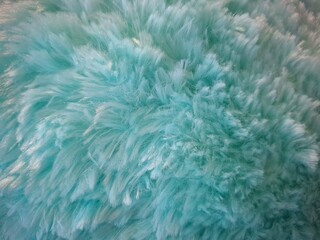 Soft pastel blue background of faux fur sweater.