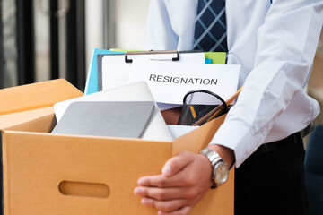 Employee packing belongings into a box during a job change or resignation