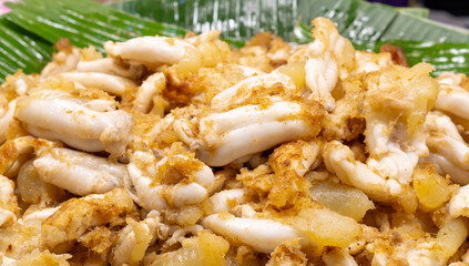 Delicious brown fried squid eggs on sale in street food market in Thailand