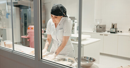 Flour, bakery and dough with woman in kitchen for coffee shop, cooking industry and meal prep. Chef, dessert and nutritionist with baker in restaurant for pastry recipe, small business and food