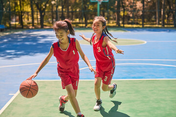 Chinese Kids Playing Basketball on Basketball Court