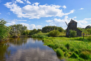 Ancient windmill on the bank of a pond in Ertil village