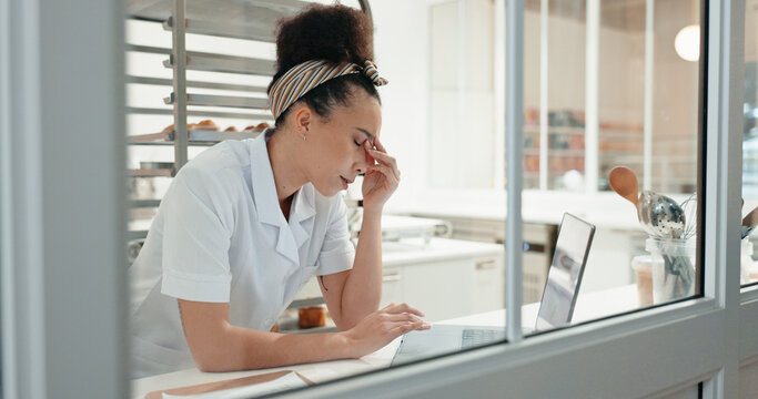 Stress, tired and laptop with chef in kitchen for online recipe, restaurant review and research at night. Fatigue, menu planning and frustrated with person in coffee shop for social media and burnout