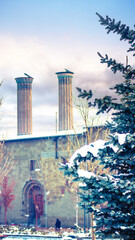 Winter scene of Erzurum's Twin Minaret Madrasa and Ulu mosqua surrounded by snow