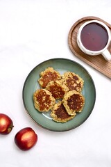 Enjoying a Cozy Breakfast with Tea, Fresh Apples, and a Snack of apple pancakes on a Beautiful Wooden Tray