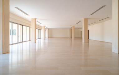 Spacious empty interior showcasing polished flooring and abundant natural light