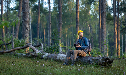 Photographer is taking photo of the new discovering bird species while exploring in the pine forest...