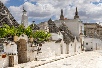 Via del Gesu with trulli houses, traditional Apulian dry stone hut with a conical roof, Alberobello, Apulia, Italy