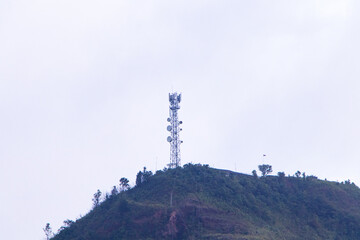 Obraz premium Antenna communication technology with satellite dish on top of mountain. Internet of Things. Communication tower connect to data of smart city. Telecommunication 5G Digital Transformation.