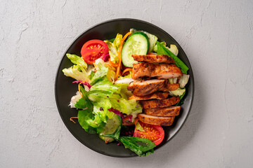 Salad and grilled chicken prepared for healthy nutrition