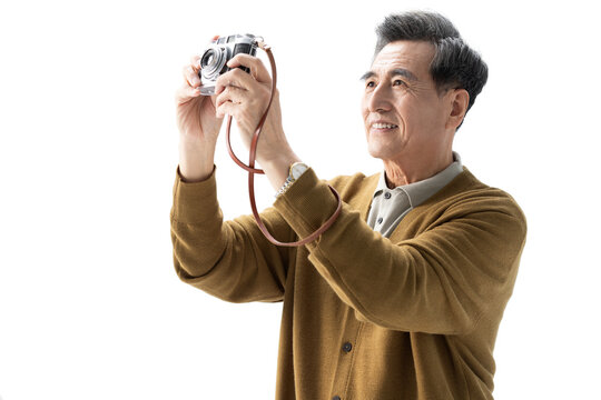 Happy senior Chinese man taking pictures with camera