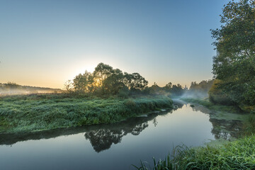 A calm river with trees in the background