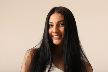 Headshot of beautiful young happy woman with long dark hair looking at the camera. Vertical mock-up.