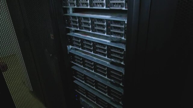 A man's hand opens the server cabinet door. The server is visible. The concept of storing data on powerful servers. Collection, processing and storage of information.