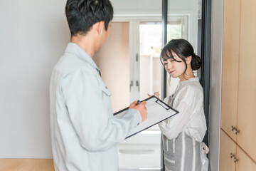 Obraz premium バスルーム・お風呂・浴槽・浴室の点検をお願いする主婦の女性 