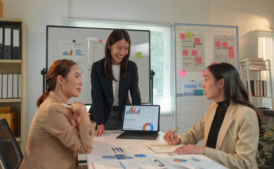 Group of business people, investors talking and meeting using documents and laptops to analyze and discuss. Presentation of financial report situation in the office. Teamwork concept, startup business