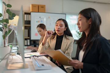 Group of business people, investors talking and meeting using documents and laptops to analyze and discuss. Presentation of financial report situation in the office. Teamwork concept, startup business