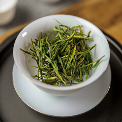 A Beautiful White Bowl Containing Freshly Picked Green Tea Leaves Ready for Brewing