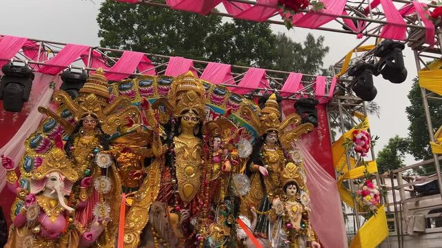 The Maa Durga idol is displayed on an open stage, accompanied by Laxmi, Saraswati, Ganesh, and Kartick.