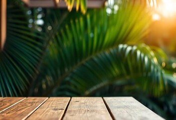 A wooden table or deck in the foreground with blurred green palm leaves and a blurred, bright background