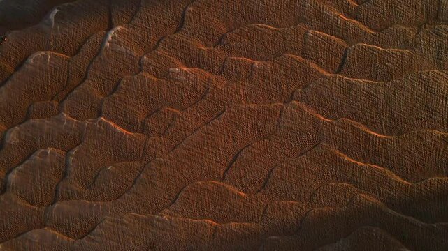 The wavy sandy soil caused by the water flowing and then the Mekong River dried up at sunset. The wavy sandy soil caused by the water flowing and then the Mekong River dried up at sunset.Nakhon Phanom