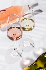 Two wine glasses filled with rose and white wine