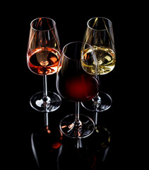 Three wine glasses filled with red, white, and rose wine