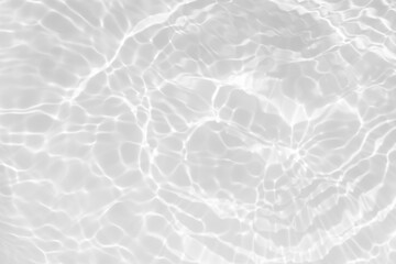 White water with ripples on the surface. Defocus blurred transparent white colored clear calm water surface texture with splashes and bubbles. Water waves with shining pattern texture background.