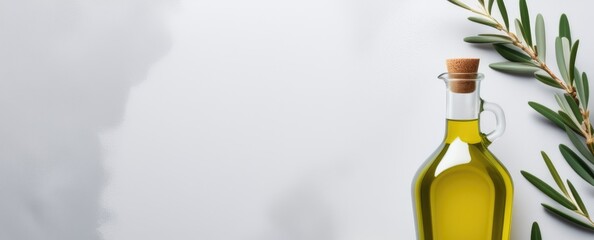 Olive oil bottle with natural leaves on minimalist background