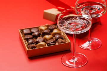 A glasses of champagne elegantly paired with a box of rich chocolates