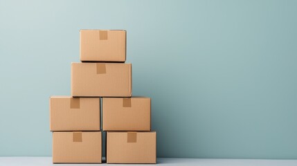 Obraz premium Stacked cardboard boxes against a blue wall background.
